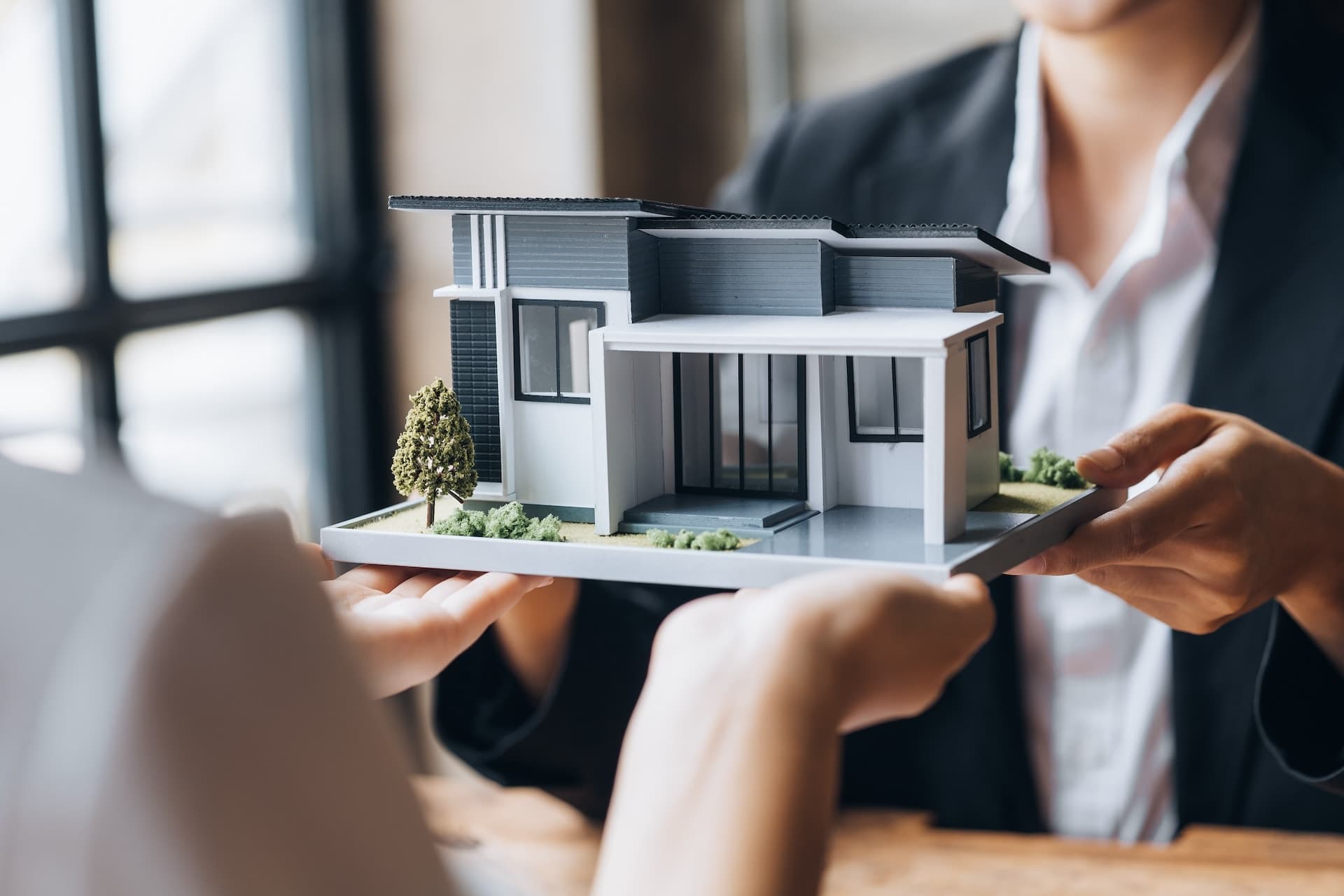 plastic model of a house in hand